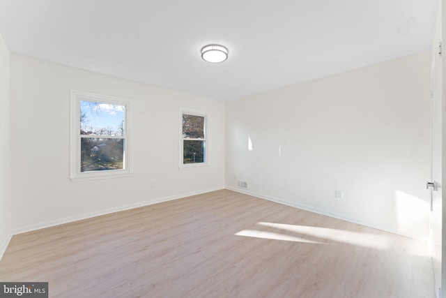 spare room featuring light wood-type flooring