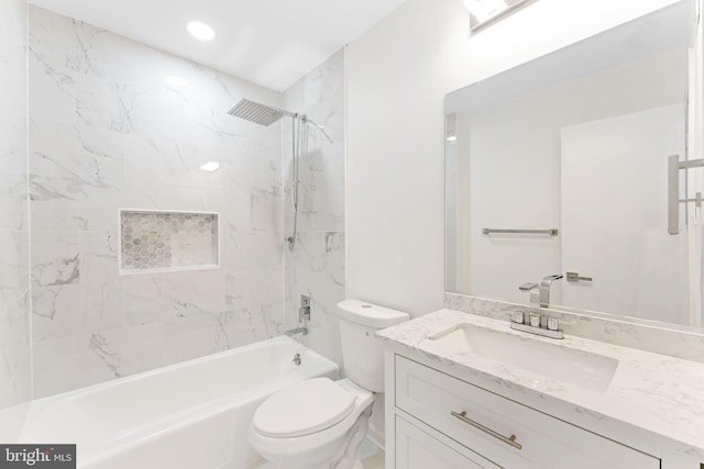 full bathroom featuring vanity, toilet, and tiled shower / bath