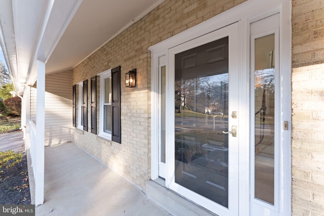 view of exterior entry featuring a porch