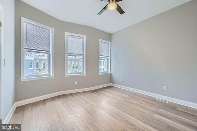 spare room featuring ceiling fan, plenty of natural light, and light wood-type flooring