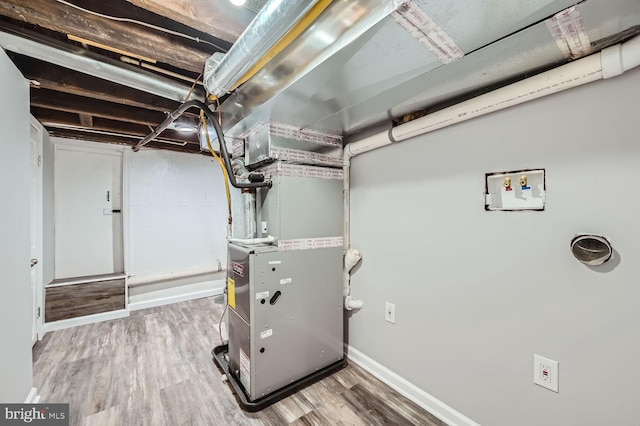 utility room featuring heating unit