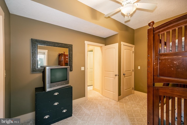 bedroom featuring ceiling fan and light carpet