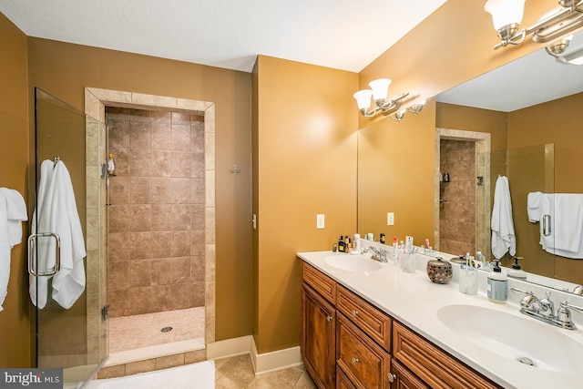 bathroom with a tile shower, tile patterned floors, vanity, and a notable chandelier