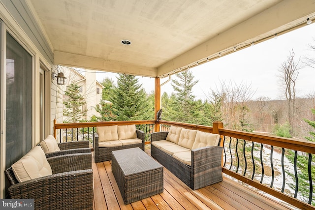 wooden terrace featuring an outdoor living space