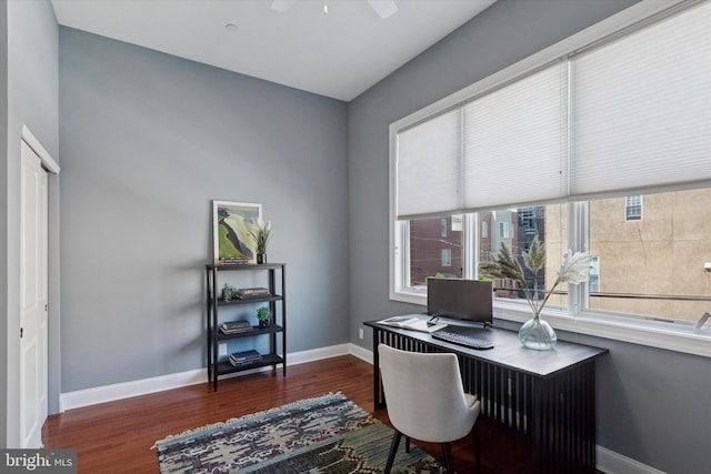 office space featuring baseboards, a ceiling fan, and wood finished floors