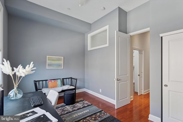 interior space featuring baseboards and wood finished floors
