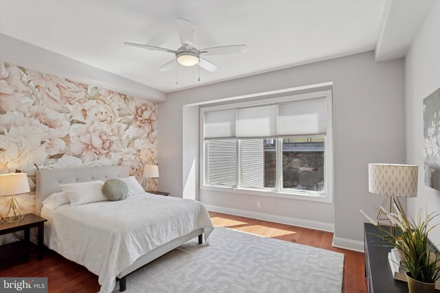bedroom featuring baseboards, ceiling fan, and wood finished floors