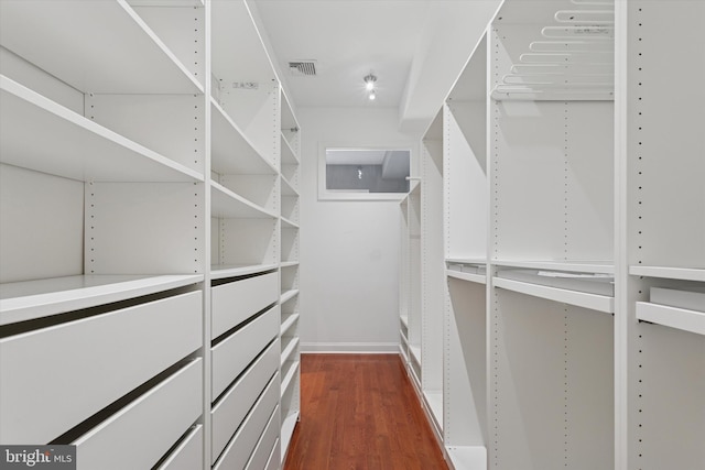 walk in closet featuring dark wood-style flooring and visible vents