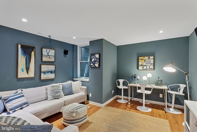 living area with baseboards, recessed lighting, and wood finished floors