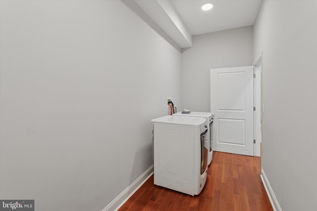 laundry area with separate washer and dryer, baseboards, laundry area, and wood finished floors