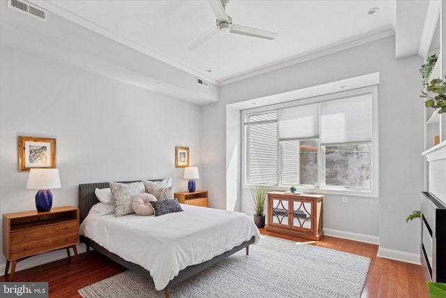 bedroom with visible vents, ornamental molding, and wood finished floors