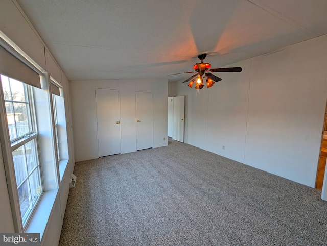 unfurnished bedroom with carpet, ceiling fan, and multiple windows