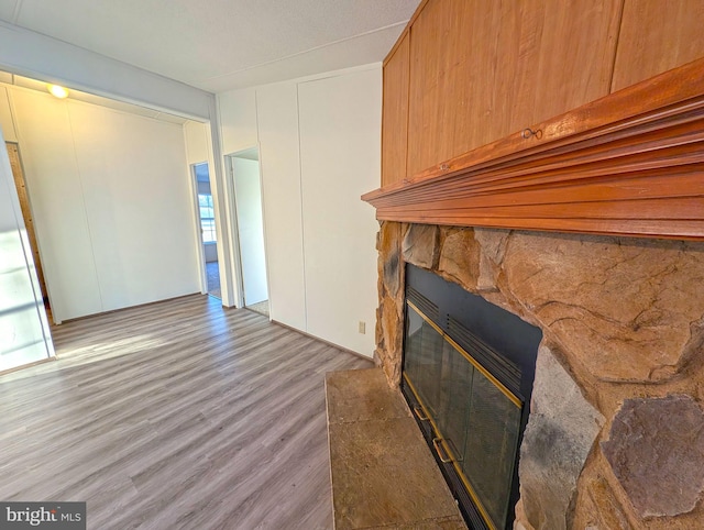 unfurnished living room with a fireplace, plenty of natural light, and light wood-type flooring