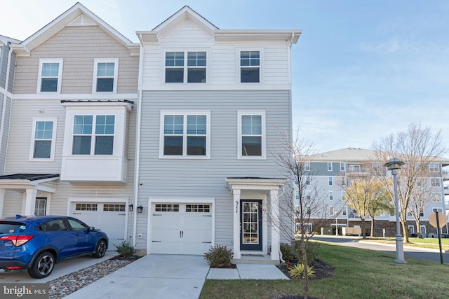 view of property with a garage and a front lawn