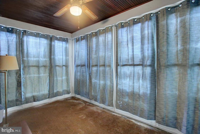 interior space featuring ceiling fan and wooden ceiling