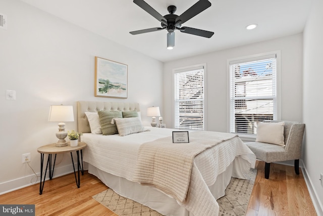 bedroom with ceiling fan and light wood-type flooring