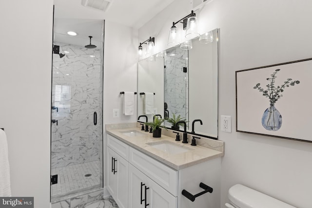 bathroom with vanity, a shower with shower door, and toilet