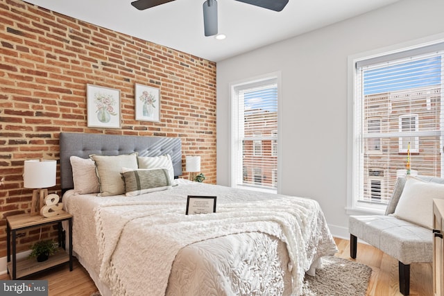 bedroom with light hardwood / wood-style flooring, multiple windows, and ceiling fan