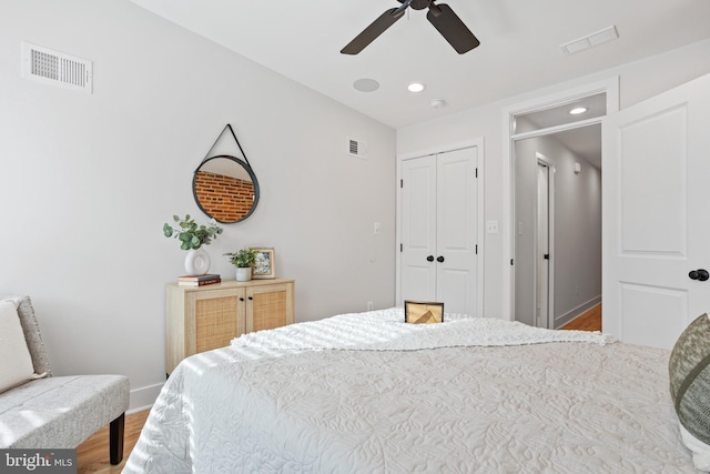 bedroom featuring hardwood / wood-style floors, a closet, and ceiling fan