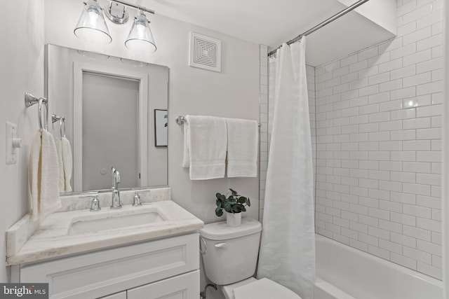 full bathroom featuring shower / tub combo, vanity, and toilet