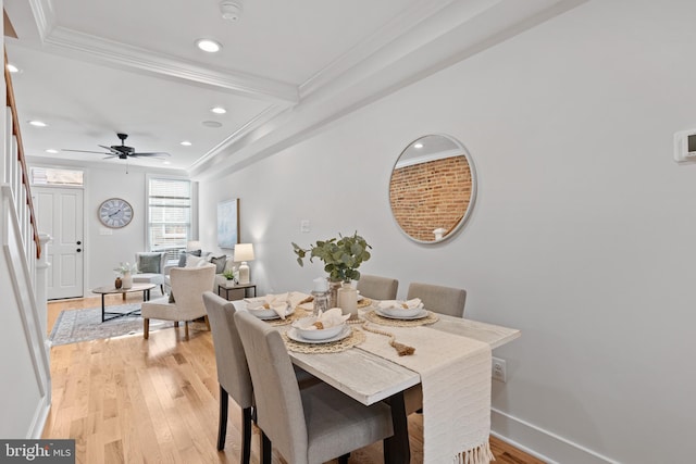 dining space with light wood-type flooring, ceiling fan, and ornamental molding