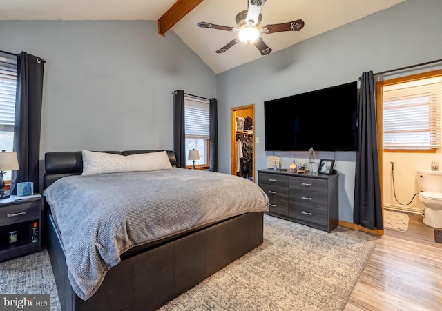 bedroom featuring multiple windows, lofted ceiling with beams, a spacious closet, and ceiling fan