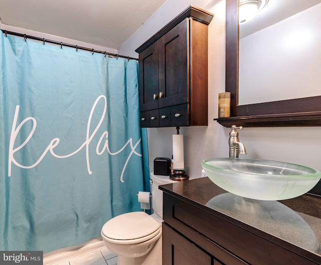 bathroom with walk in shower, vanity, and toilet