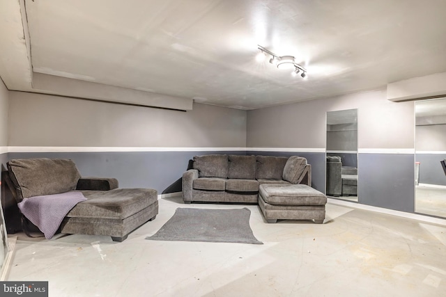 living room with concrete flooring and rail lighting