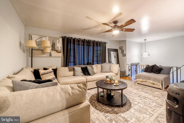 living room featuring wood-type flooring and ceiling fan