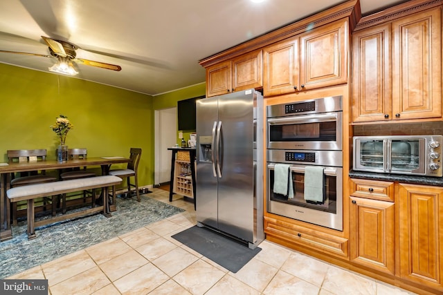 716 Marshall St, Edgewater Park, NJ 08010 - kitchen featuring stainless steel appliances, a ceiling fan, light tile patterned floors, brown cabinets, and backsplash