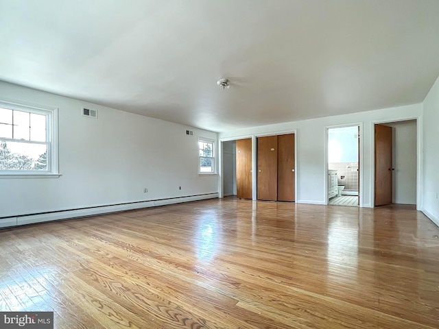 spare room with light hardwood / wood-style flooring and a baseboard radiator