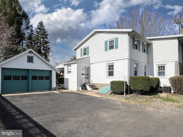 view of front of house featuring a garage and an outdoor structure