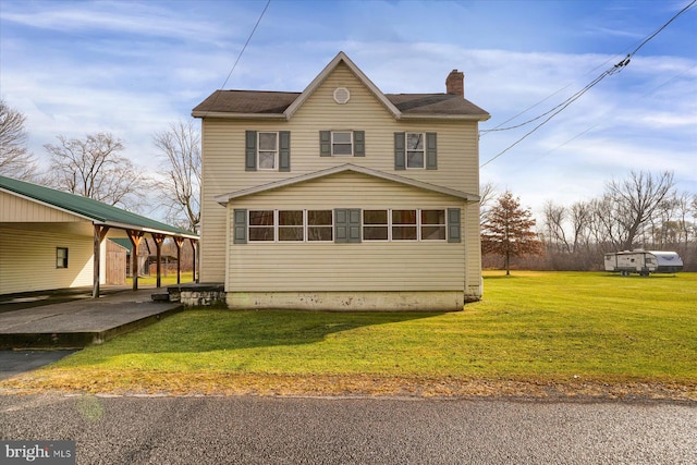 view of property exterior with a carport and a yard