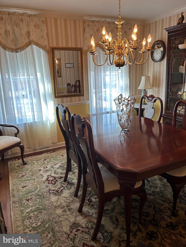 9221 Greenhouse Cir, Nottingham, MD 21236 - dining space with wallpapered walls, a chandelier, ornamental molding, healthy amount of natural light, and wood finished floors