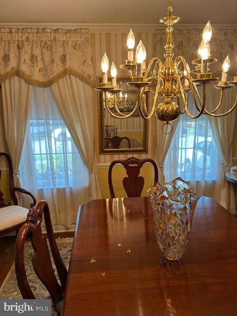 dining area featuring crown molding and hardwood / wood-style floors