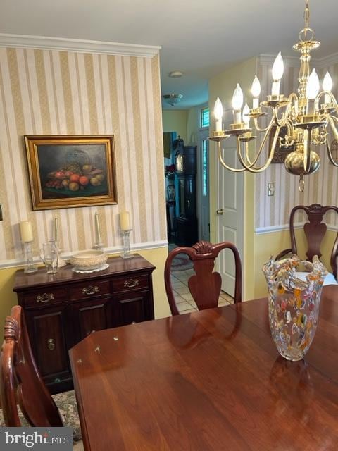 dining area featuring a chandelier and crown molding