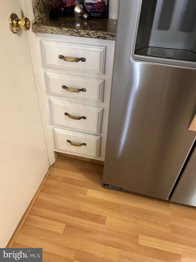 9221 Greenhouse Cir, Nottingham, MD 21236 - detailed view of smart refrigerator, white cabinetry, light wood finished floors, and dark stone counters