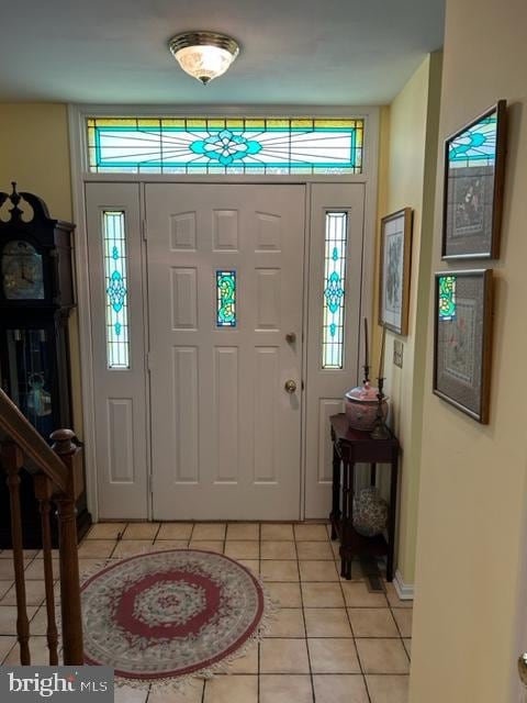 tiled entryway featuring a wealth of natural light