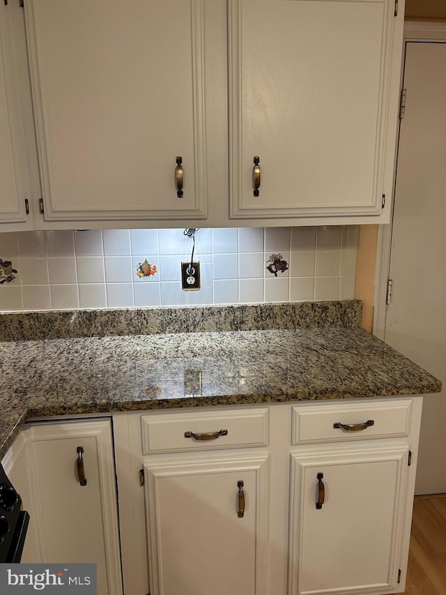 9221 Greenhouse Cir, Nottingham, MD 21236 - kitchen featuring white cabinets, backsplash, dark stone counters, and wood finished floors