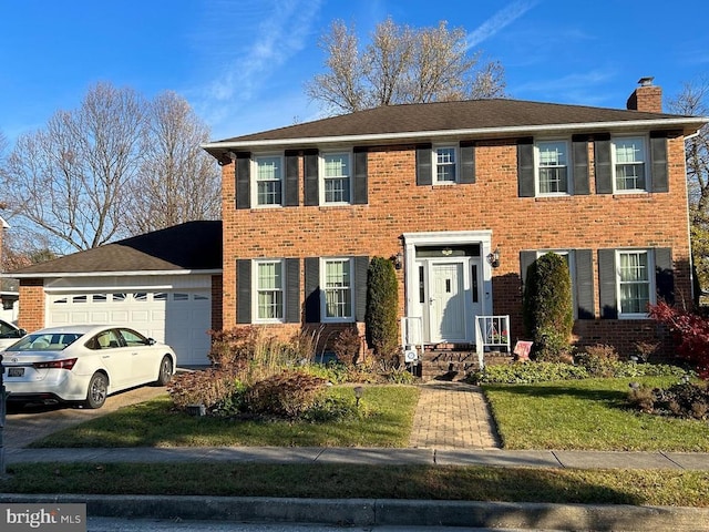 9221 Greenhouse Cir, Nottingham, MD 21236 - colonial inspired home with a chimney, an attached garage, brick siding, and a front lawn