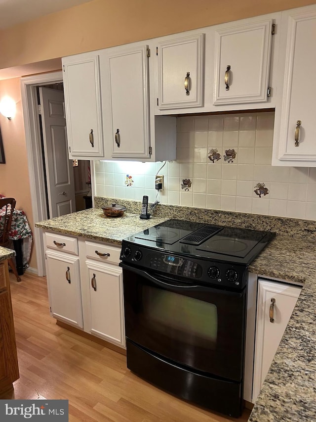 9221 Greenhouse Cir, Nottingham, MD 21236 - kitchen featuring electric range, white cabinets, light wood-style floors, decorative backsplash, and light stone counters