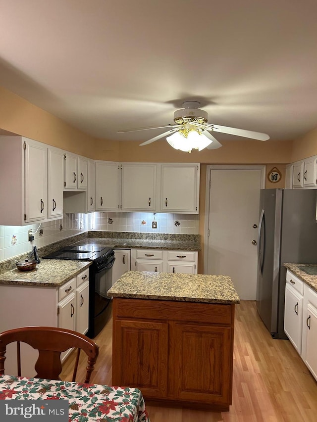 9221 Greenhouse Cir, Nottingham, MD 21236 - kitchen featuring black electric range oven, a ceiling fan, a center island, and white cabinets