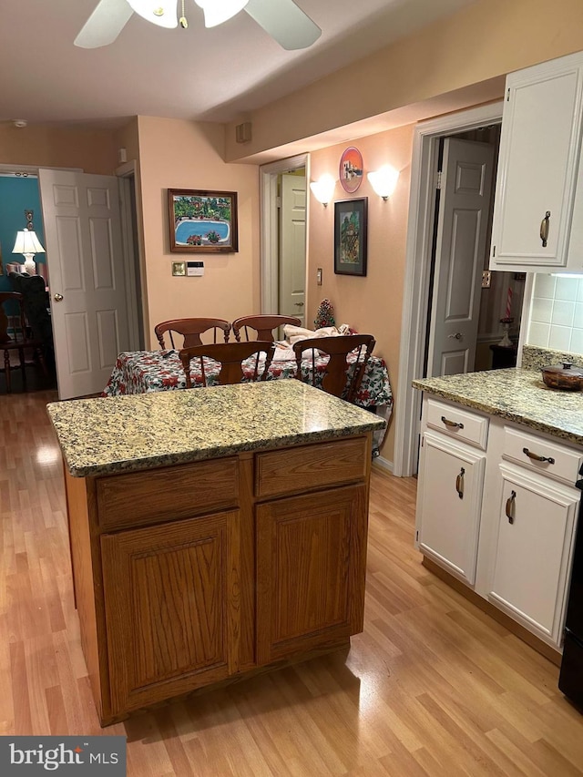 9221 Greenhouse Cir, Nottingham, MD 21236 - kitchen featuring light wood-style floors, a ceiling fan, white cabinets, and a kitchen island