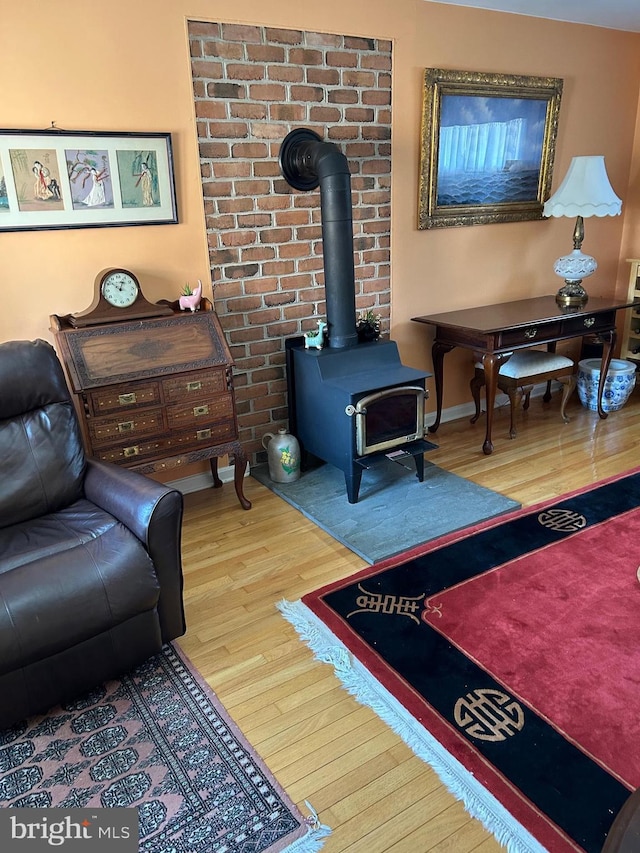 9221 Greenhouse Cir, Nottingham, MD 21236 - living room featuring wood finished floors and a wood stove