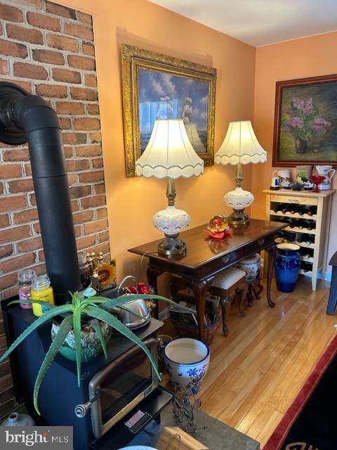 interior space with hardwood / wood-style floors and a wood stove