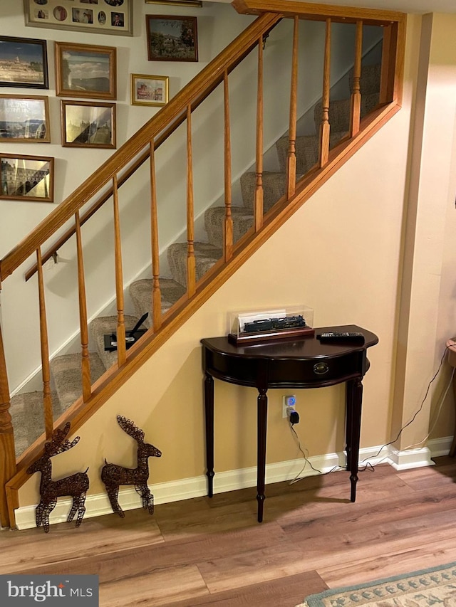 stairs featuring wood-type flooring