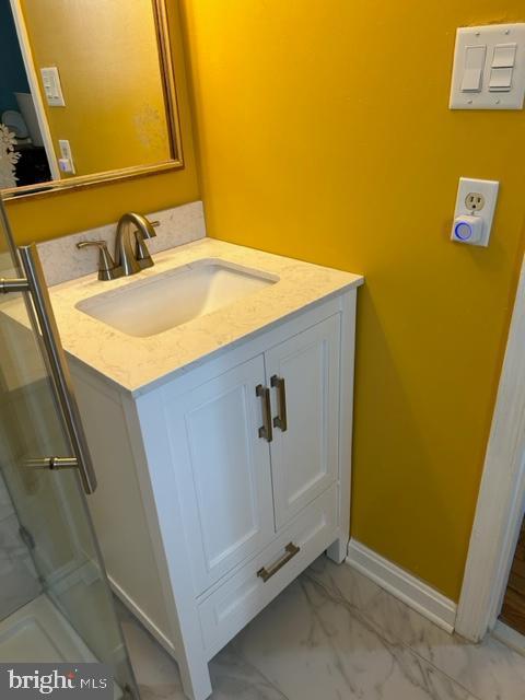 9221 Greenhouse Cir, Nottingham, MD 21236 - bathroom with marble look tile flooring, vanity, and a shower