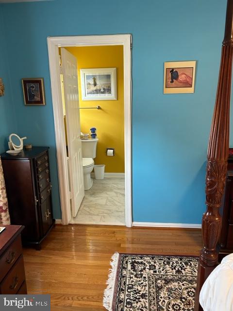 bathroom featuring hardwood / wood-style floors and toilet