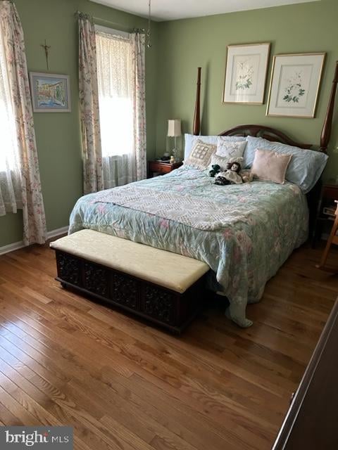 bedroom with hardwood / wood-style flooring