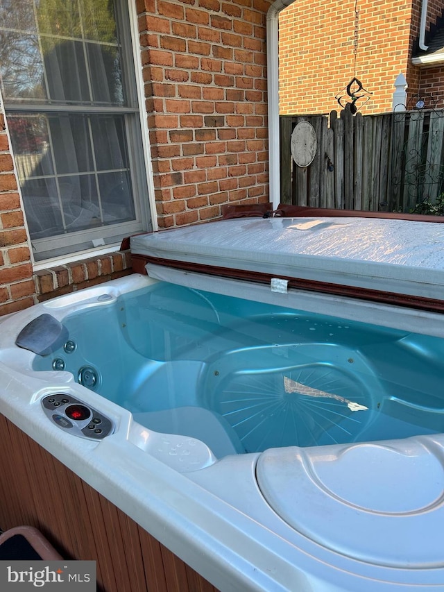 9221 Greenhouse Cir, Nottingham, MD 21236 - exterior view of brick siding and a hot tub